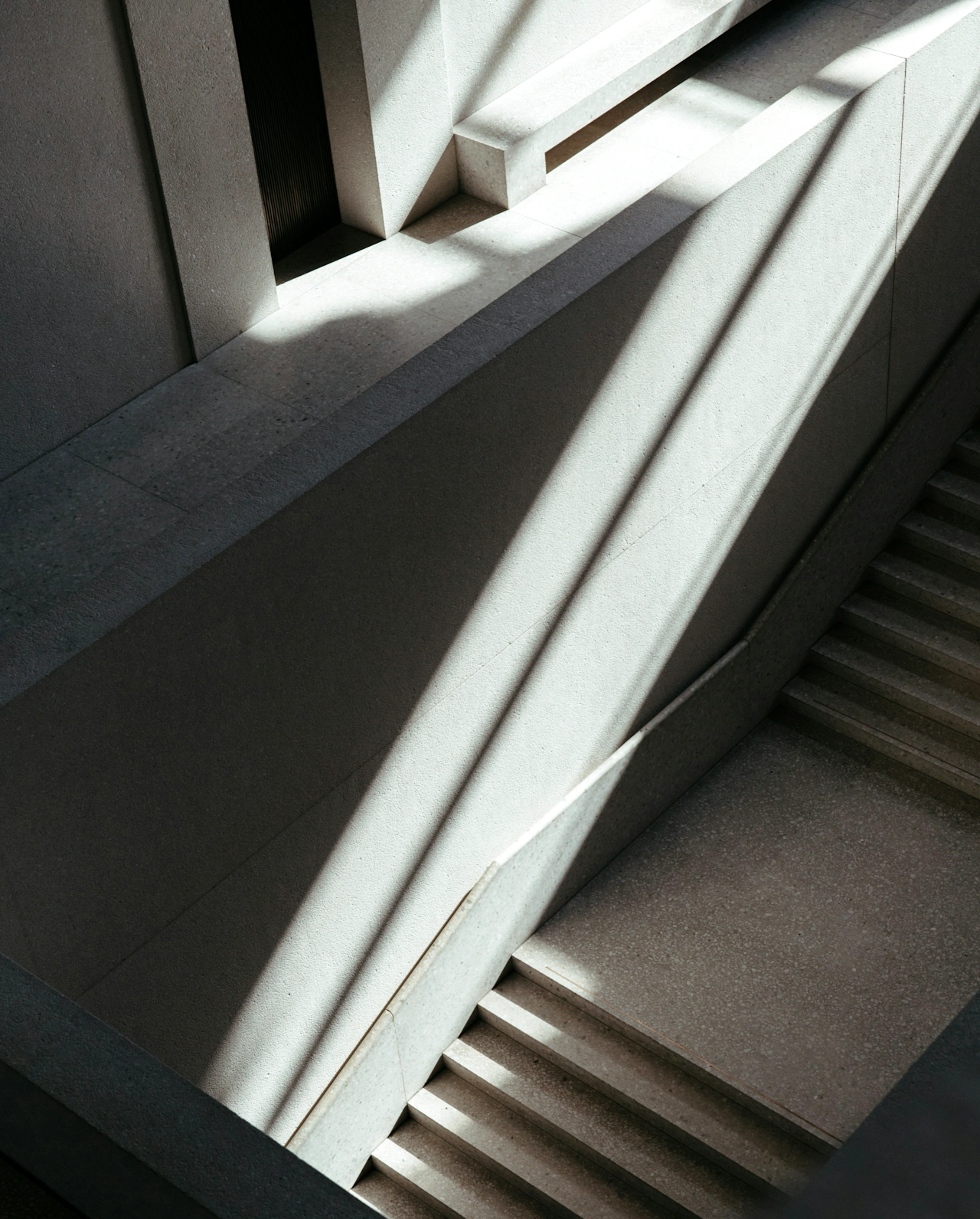 Staircase with natural light shining through panels