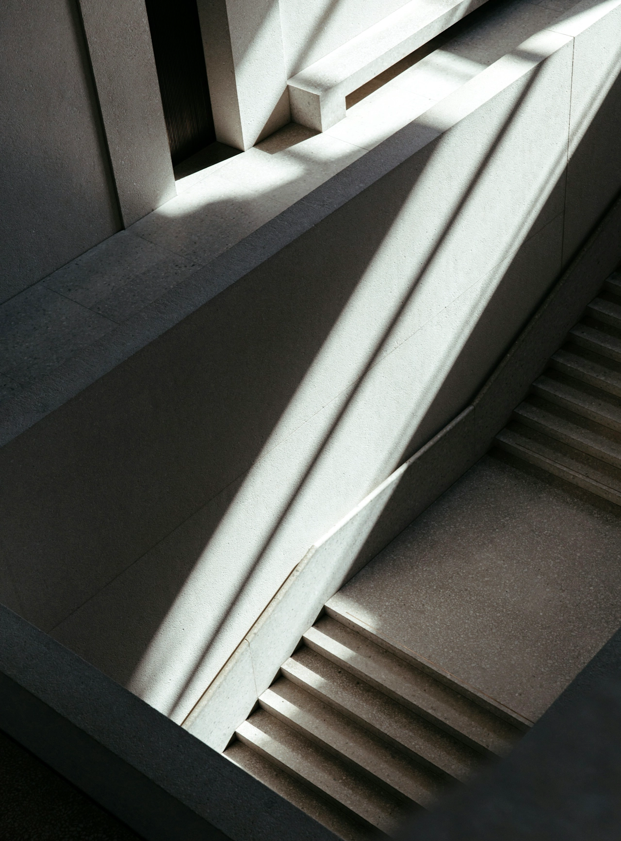 Dark staircase with panels of natural light.