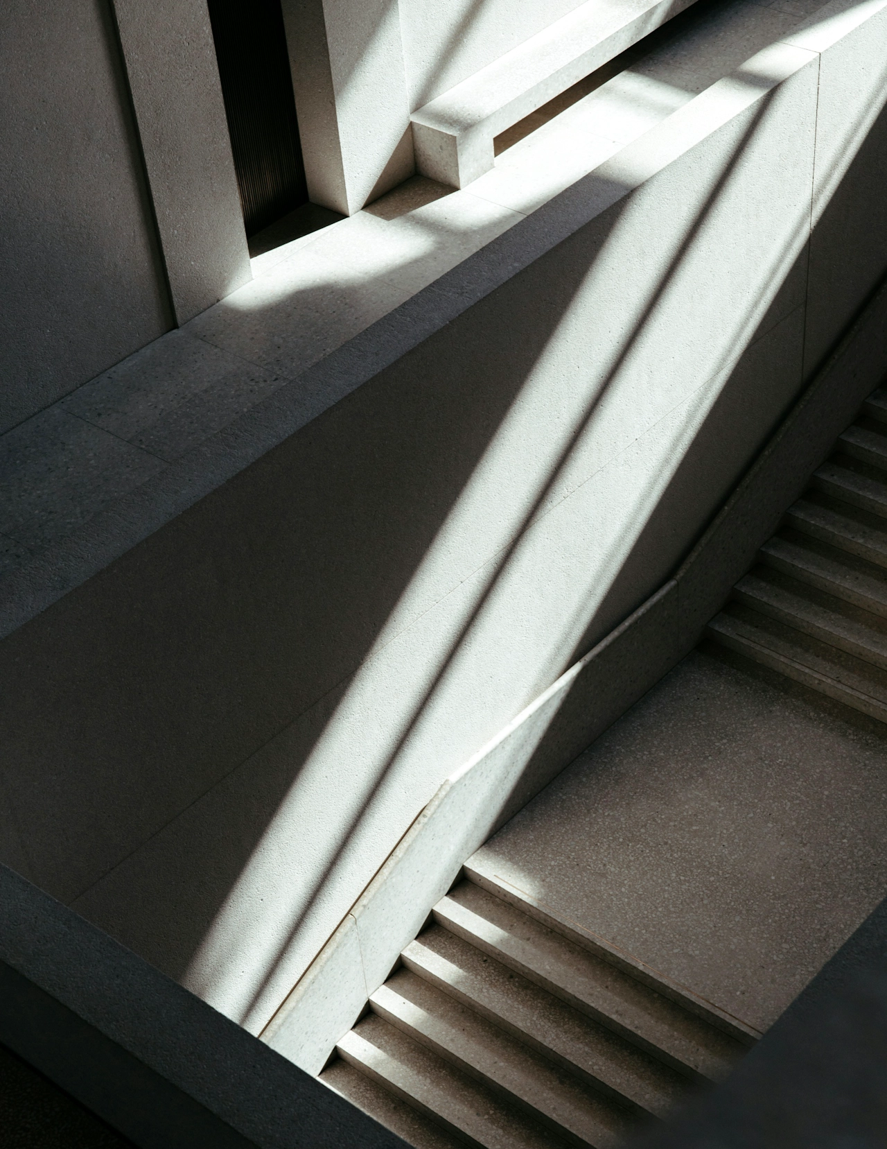 Dark staircase with panels of natural light.