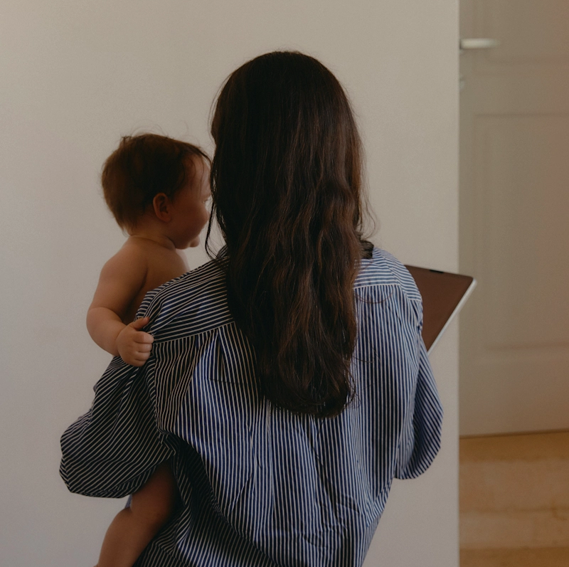 Woman holding baby and an iPad